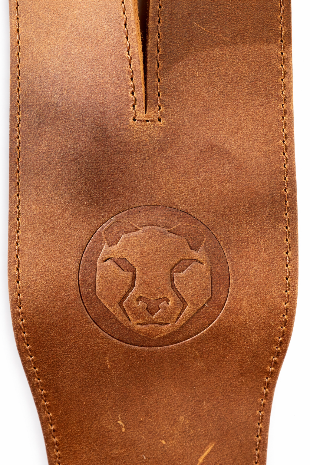 Brown leather lifting strap with a circular embossed design on a white background